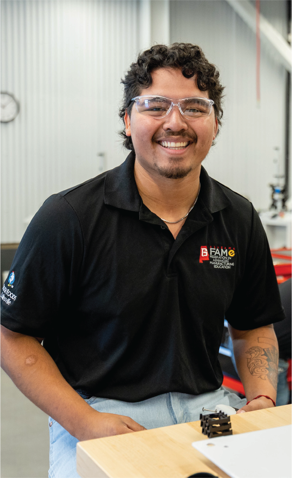 Student at Gadsden State setting at deak smiling