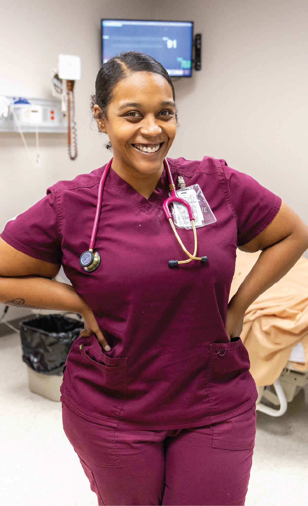 Student at Gadsden State wearing scrubs and smiling