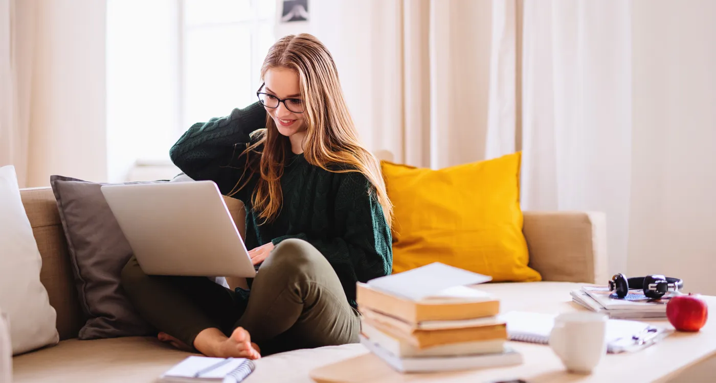 Student on laptop at home on couch