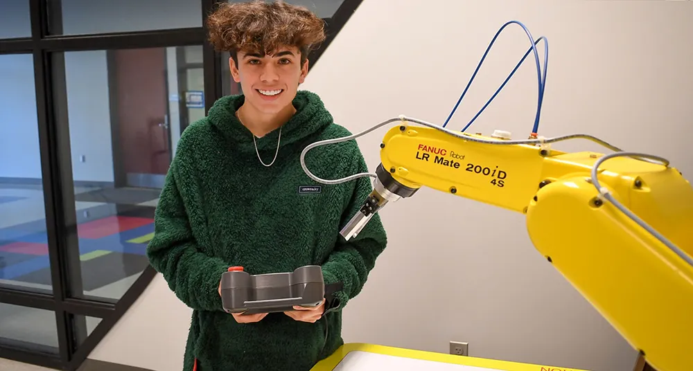 Student with robotic arm in lab