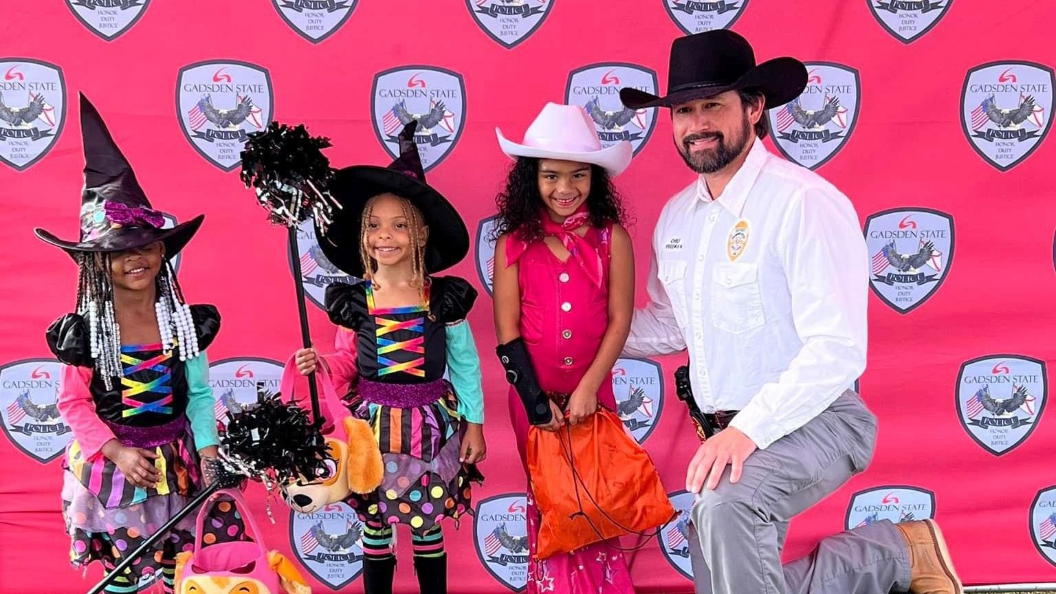 Gadsden State Chief of Police poses with trick-or-treaters at the college’s Candy with a Cardinals event in October 2023.