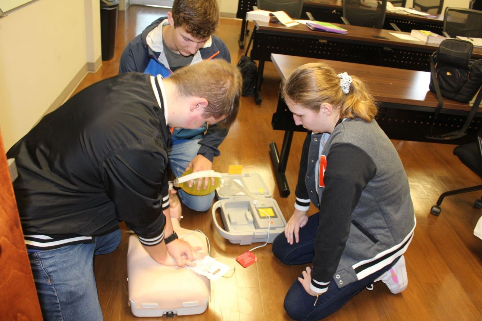 Fifteen high school seniors from Calhoun County are working towards an EMT certification through Gadsden State’s program at Anniston Regional Training Center. Practicing their CPR skills are, from left, Brody Wright, Will Collins and Kaytlyn Gardner.
