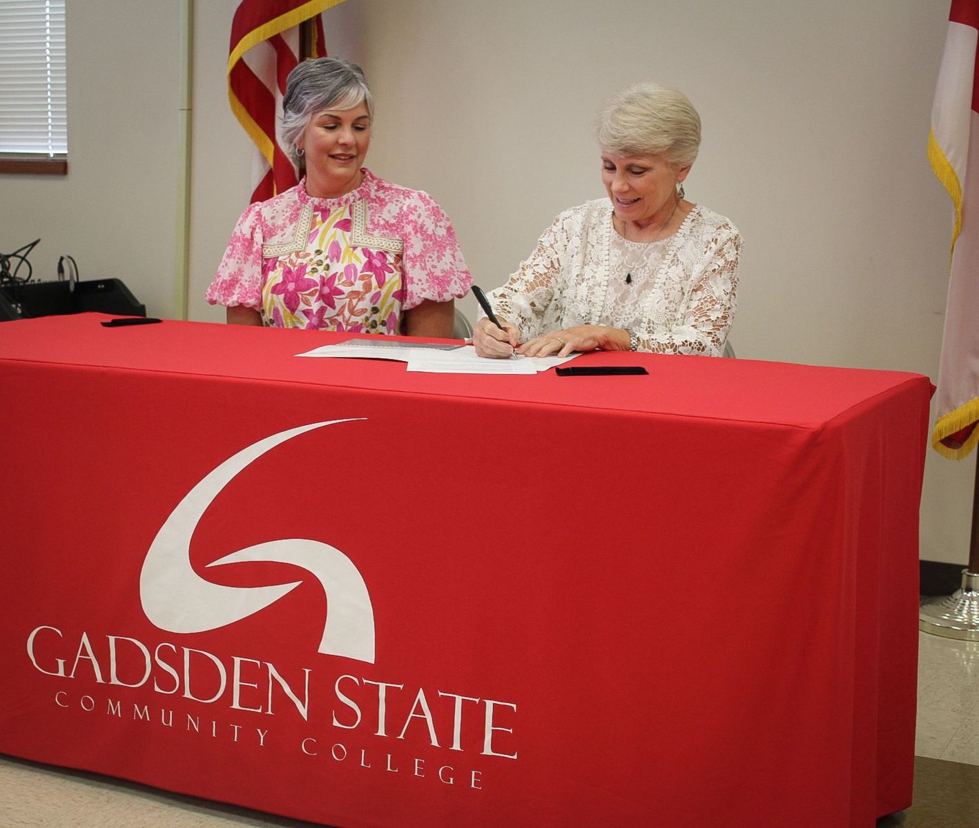 Dr. Kathy Murphy, president of Gadsden State, right, signs the MOU for the BOGO Scholarship. She is joined by Aimee Kilgo, president of the Cherokee Chamber of Commerce Board of Directors.