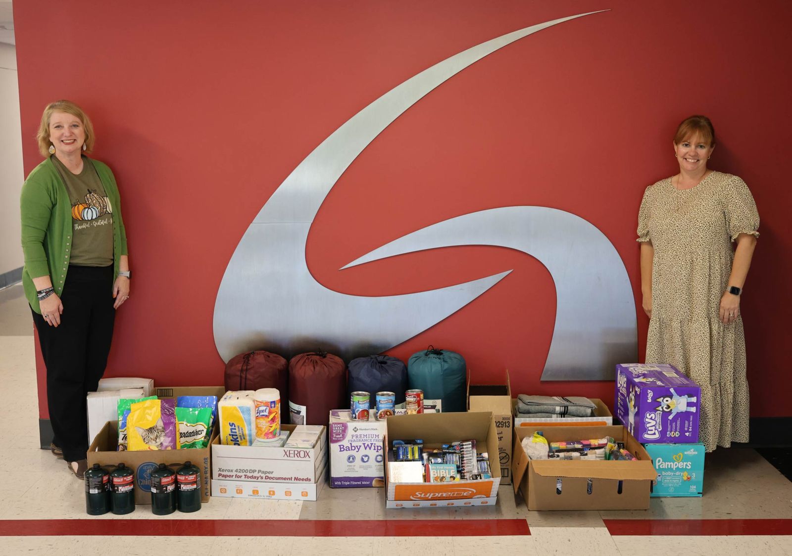 Tina Pendley, left, recruited members of Phi Theta Kappa Honor Society to help her collect donations on Gadsden State’s five campuses to donate to Hurricane Helene survivors in North Carolina. She is pictured with some of the items donated as well as with Melissa Davis, PTK advisor.