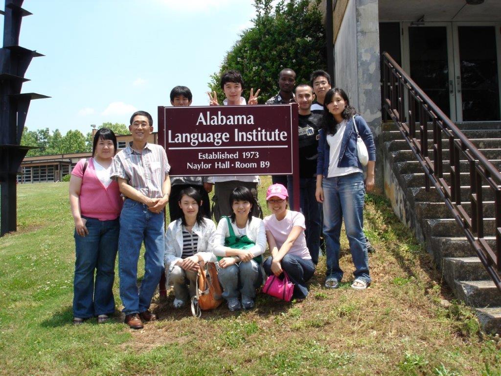 Students with the Alabama Language Institute signage