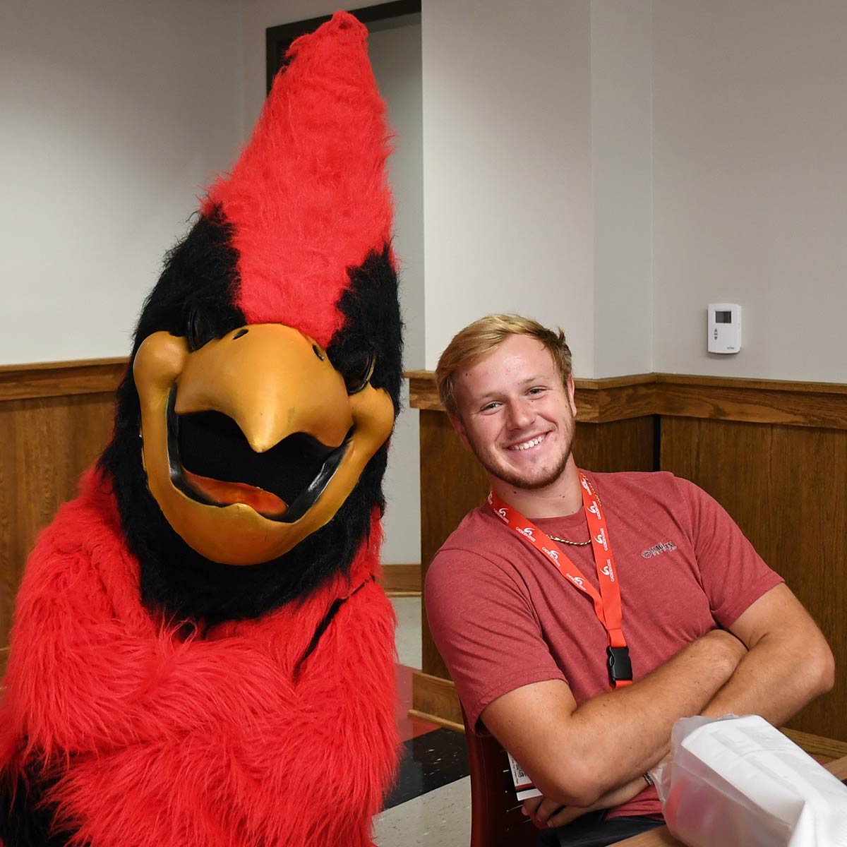 Cardinal mascot Swoop with a student at orientation