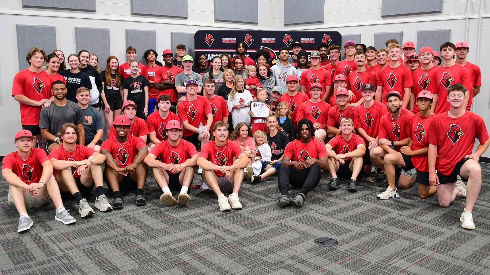 Members of Cardinal Athletics teams at a community event in the Beck Conference Center