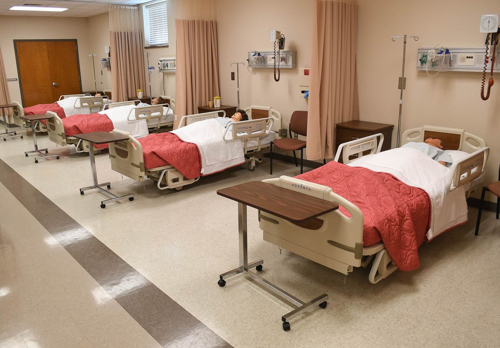 A row of healthcare beds in the Helderman Hall simulation center